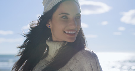 Image showing Girl In Autumn Clothes Smiling on beach