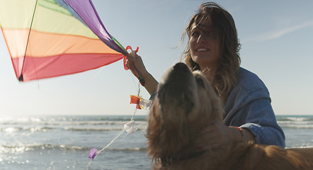 Image showing Woman holding kite at beach on autumn day