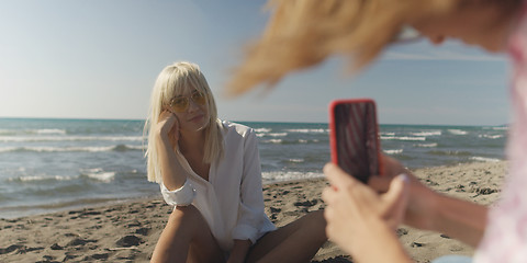 Image showing Two girl friends having fun photographing each other on vecation