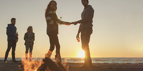 Image showing Friends having fun at beach on autumn day