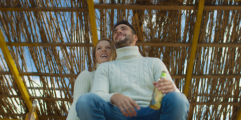Image showing Couple drinking beer together at the beach