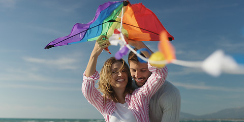 Image showing Happy couple having fun with kite on beach