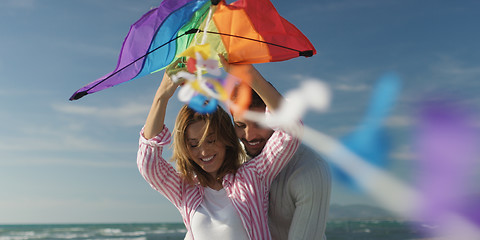 Image showing Happy couple having fun with kite on beach