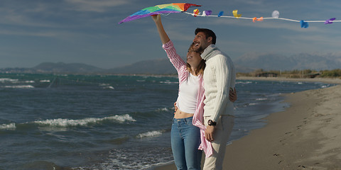 Image showing Happy couple having fun with kite on beach