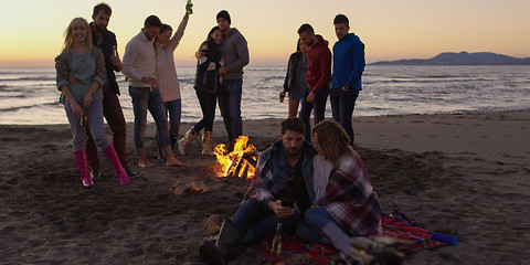 Image showing Friends having fun at beach on autumn day