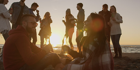 Image showing Friends having fun at beach on autumn day