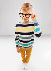 Image showing smiling boy in glasses and striped pullover