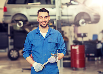 Image showing auto mechanic or smith with wrench at car workshop