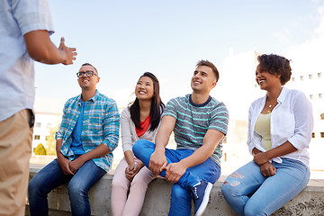 Image showing happy international friends talking in city