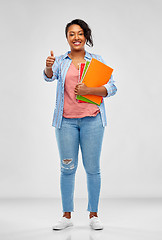 Image showing african student with notebooks showing thumbs up