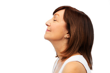 Image showing profile of smiling senior woman over white