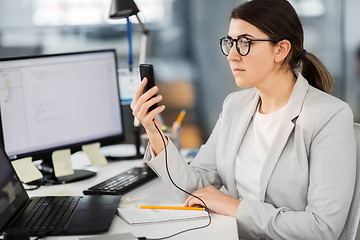 Image showing businesswoman using smartphone at office
