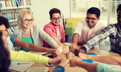 Image showing group of international students making fist bump