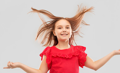 Image showing happy girl in red shirt with waving hair