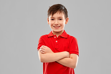 Image showing smiling boy in red t-shirt with crossed arms