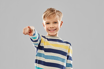 Image showing smiling boy in striped pullover pointing finger