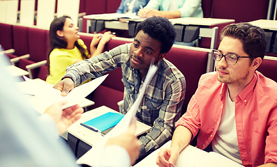 Image showing teacher giving tests to students at lecture