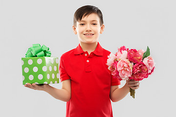 Image showing smiling boy with birthday gift box and flowers