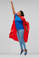 Image showing african american woman in superhero cape flying up