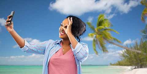 Image showing african american woman taking selfie by smartphone