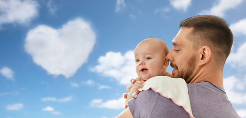 Image showing father with little baby girl over blue sky