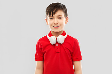 Image showing smiling boy in red t-shirt with headphones on neck