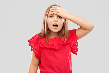 Image showing shocked girl holding to her head