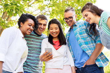 Image showing happy friends with smartphone at summer park