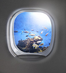 Image showing View of cloudy blue clear sky through airplane porthole.