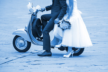 Image showing Young newlywed just married, posing on an old scooter. Clas