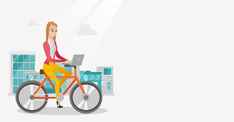 Image showing Business woman riding a bicycle with a laptop.