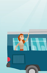 Image showing Young caucasian woman waving hand from bus window.