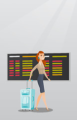 Image showing Caucasian woman walking with suitcase at airport.