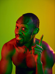 Image showing Close up portrait of a young naked african man looking at camera indoors