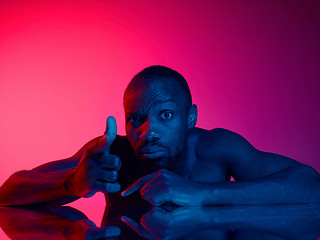 Image showing Close up portrait of a young naked african man looking at camera indoors