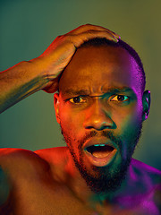 Image showing Close up portrait of a young naked african man looking at camera indoors