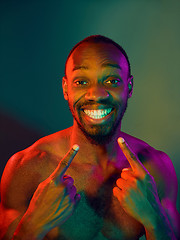 Image showing Close up portrait of a young naked african man looking at camera indoors