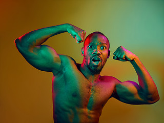 Image showing Close up portrait of a young naked african man looking at camera indoors