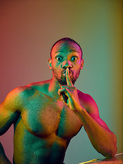 Image showing Close up portrait of a young naked african man looking at camera indoors