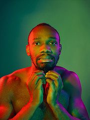 Image showing Close up portrait of a young naked african man looking at camera indoors