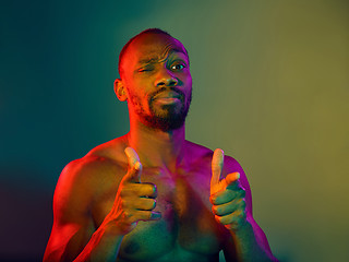 Image showing Close up portrait of a young naked african man looking at camera indoors