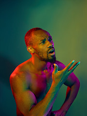 Image showing Close up portrait of a young naked african man looking at camera indoors