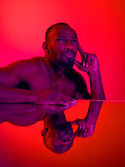 Image showing Close up portrait of a young naked african man looking at camera indoors