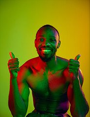 Image showing Close up portrait of a young naked african man looking at camera indoors