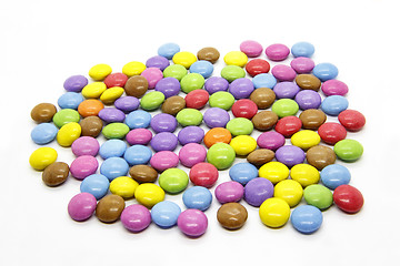 Image showing Bright multicolored glazed chocolate candies on white