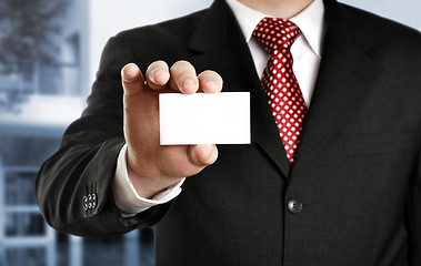 Image showing Businessman showing his business card, focus on fingers and card