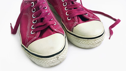 Image showing Old crimson sneakers on white background