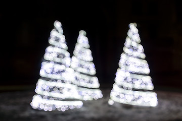 Image showing Wonderful holiday fir-tree illumination of sparkling white bokeh background