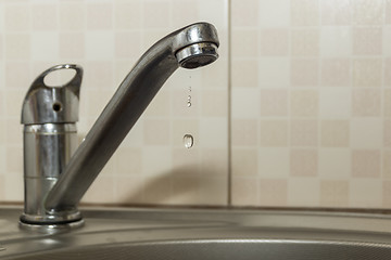 Image showing Water dripping from the faucet due to leakage