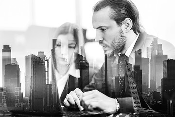 Image showing Business people in modern office against new york city manhattan buildings and skyscrapers window reflections.